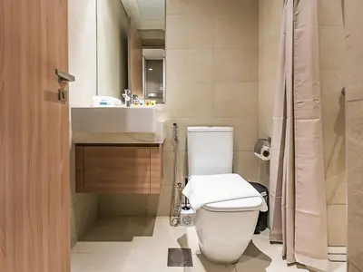 a bathroom with a toilet and a sink at Tranquil Studio Getaway in Meydan City in Dubai