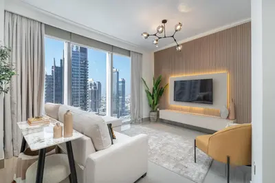 a living room with a white couch and a tv at Luxury Apartment in the Heart of Downtown Dubai in Dubai