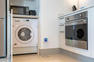 a laundry room with a washer and dryer at Luxury Apartment in the Heart of Downtown Dubai in Dubai