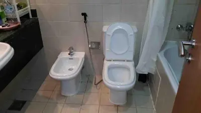 a bathroom with a toilet and a sink at Private Rooms in CoLiving Apartments UP Tower DIFC in Dubai