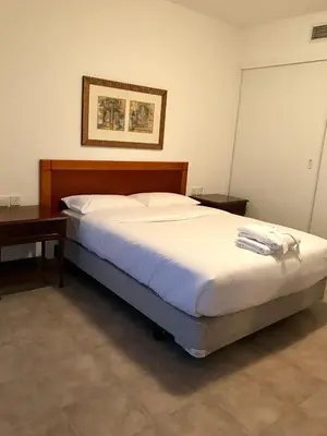 a bed in a room with a desk and a bed sidx sidx sidx at Private Rooms in CoLiving Apartments UP Tower DIFC in Dubai