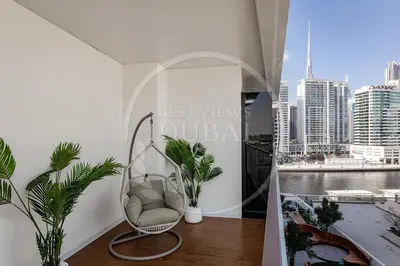 a balcony with a chair and a view of a city at Luxury 2Bdr Apartment in Business Bay in Dubai