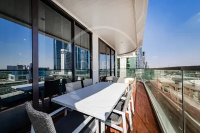 a white table and chairs in a room with windows at Luxury 2Bdr Apartment in Business Bay in Dubai