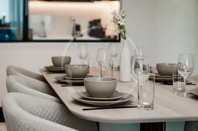 a dining room table with plates and glasses on it at Luxury 2Bdr Apartment in Business Bay in Dubai