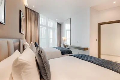a bedroom with two beds and a large window at Modern 2-Bedroom Apartment Near Burj Khalifa & Dubai Mall in Dubai