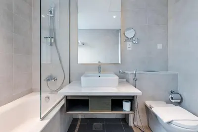 a bathroom with a sink and a shower and a toilet at Modern 2-Bedroom Apartment Near Burj Khalifa & Dubai Mall in Dubai