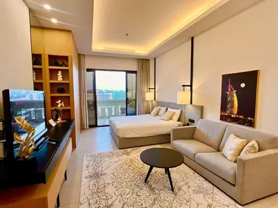 a living room with a couch and a bed and a television at Palm Jumeirah, Studio, Fantastischer Meer-, Beach- und Skyline Blick, Strand in Dubai