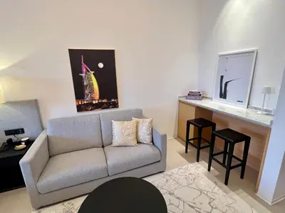 a living room with a couch and a table at Palm Jumeirah, Studio, Fantastischer Meer-, Beach- und Skyline Blick, Strand in Dubai