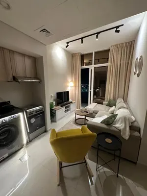 a living room with a couch and a yellow chair at Cozy Golf & Lake View 1BR Apartment,Damac Hills 1 in Dubai