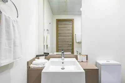 a bathroom with a sink and a toilet at Superhost - Bright & Stylish 1-Bedroom in Bloom Tower, JVC in Dubai