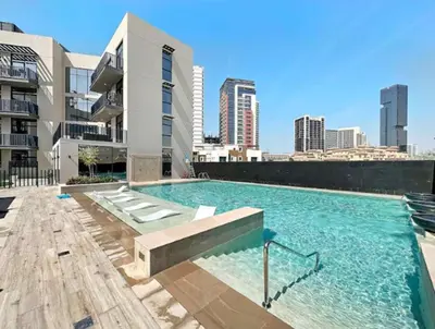 a swimming pool on the roof of a building at HAVN - 1 Bedroom in Harrington House, JVC in Dubai