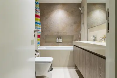a bathroom with a toilet and a sink at downtown views 1108 burj in Dubai