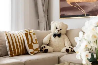a teddy bear sitting on top of a couch at downtown views 1108 burj in Dubai