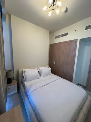 a bedroom with a large bed with white sheets and pillows at Special Offer Rental One Bedroom Apartment at Azizi Riviera Dubai in Dubai
