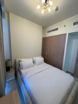 a bedroom with a large bed with white sheets and pillows at Special Offer Rental One Bedroom Apartment at Azizi Riviera Dubai in Dubai