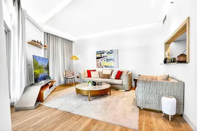 a living room with a couch and a table at Trendy 2BR Direct Mall Access Burj View High Floor in Dubai
