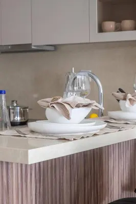 a kitchen counter with plates and dishes on it at Frank Porter - Escan Tower in Dubai