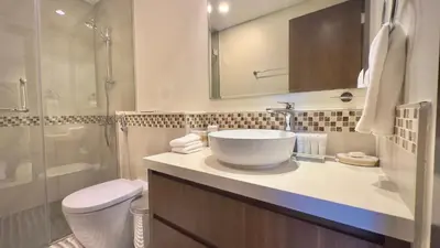a bathroom with a sink and a toilet and a shower at Sleek & Spacious 2BR in DAMAC Vera, Business Bay by Bhavan Vacation Homes in Dubai
