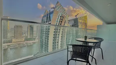 a table and chair on a balcony with a view of a city at Sleek & Spacious 2BR in DAMAC Vera, Business Bay by Bhavan Vacation Homes in Dubai