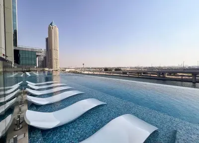 a row of white seats on the roof of a building at Modern 2BR Canal-Side Elegance in Dubai