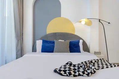 a bedroom with a bed with blue and white pillows at Modern Boutique Studio with Burj Khalifa View in Dubai