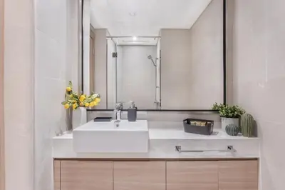 a bathroom with a white sink and a mirror at Modern Boutique Studio with Burj Khalifa View in Dubai