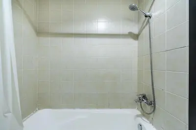 a bathroom with a bath tub with a shower at Stunning Hideaway in Dubai Marina in Dubai