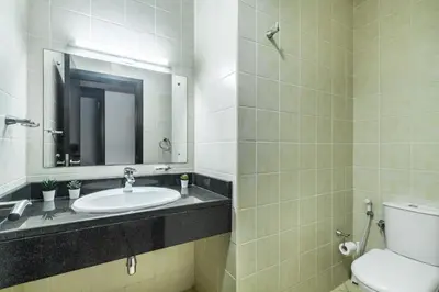 a bathroom with a sink and a toilet and a mirror at Stunning Hideaway in Dubai Marina in Dubai