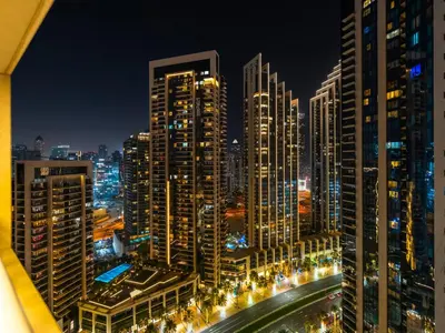 a city skyline at night with tall buildings at Royal Vista - Luxury 3BR Apartment at 29 Boulevard Tower - Downtown in Dubai