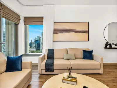 a living room with a couch and a table at Royal Vista - Luxury 3BR Apartment at 29 Boulevard Tower - Downtown in Dubai