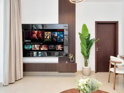 a living room with a flat screen tv on a wall at Royal Vista - Luxury 3BR Apartment at 29 Boulevard Tower - Downtown in Dubai