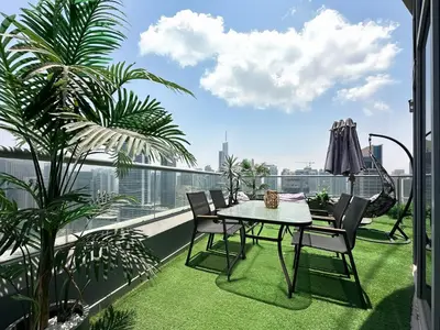 a patio with a table and chairs on a balcony at Trophy - Luxury Waterfront 2BR with Big Terrace Full Marina Canal Views in Dubai