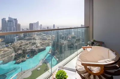 a chair in a room with a view of a city at Frank Porter - Grande Signature Residence in Dubai