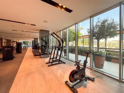 a gym with treadmills and ellipticals in a building at Frank Porter - Grande Signature Residence in Dubai