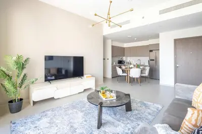a living room with a couch and a table at Frank Porter - Grande Signature Residence in Dubai