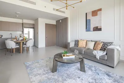 a living room with a couch and a table at Frank Porter - Grande Signature Residence in Dubai