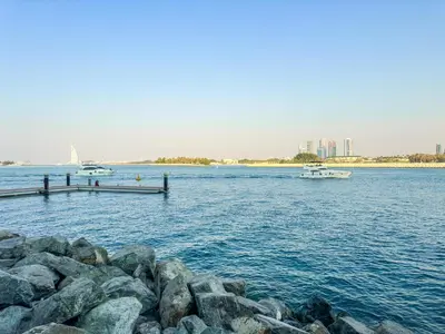 a large body of water with a pier and boats at Azure Residences a Beachfront Getaway on Palm Jumeirah in Dubai