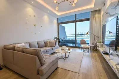 a living room with a couch and a table at Azure Residences a Beachfront Getaway on Palm Jumeirah in Dubai