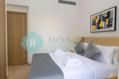 a bedroom with a white bed with a sign on it at Bloomfields Stylish 1br In Azizi Riviera in Dubai