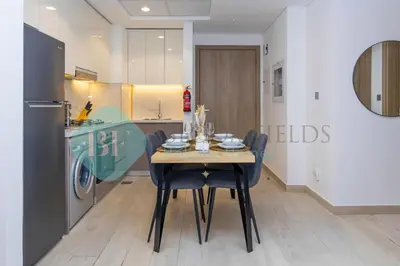 a kitchen and dining room with a table and chairs at Bloomfields Stylish 1br In Azizi Riviera in Dubai