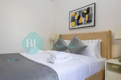 a bedroom with a bed with two towels on it at Bloomfields Stylish 1br In Azizi Riviera in Dubai
