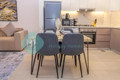 a dining room table and chairs in a kitchen at Bloomfields Stylish 1br In Azizi Riviera in Dubai