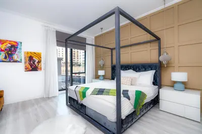 a bedroom with a canopy bed in a room at White Sage Spacious 1BR at Marina Promenade in Dubai