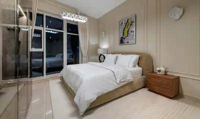 a bedroom with a large bed and a window at Usmans Brand New Duplex Apartment 5 Bedrooms Dubai Marina Trident Bayside 4 Rooms with 4 En-suite Washrooms in Dubai