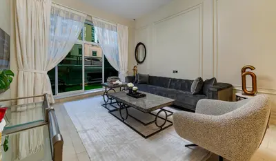 a living room with a couch and a table at Usmans Brand New Duplex Apartment 5 Bedrooms Dubai Marina Trident Bayside 4 Rooms with 4 En-suite Washrooms in Dubai