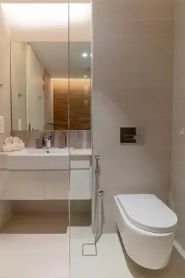 a bathroom with a toilet and a sink and a mirror at 2BDR Apartment in Bluewaters Luxury Area in Dubai