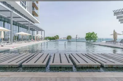 a pool of water with benches in a building at 2BDR Apartment in Bluewaters Luxury Area in Dubai