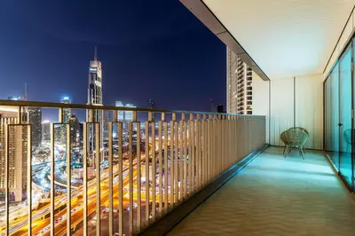 a balcony with a view of a city at night at 3 Bedrooms Apartment in Downtown Views - Dubai Burj Khalifa View in Dubai