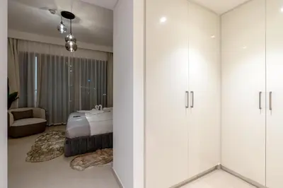 a bedroom with a bed and white cabinets at 3 Bedrooms Apartment in Downtown Views - Dubai Burj Khalifa View in Dubai
