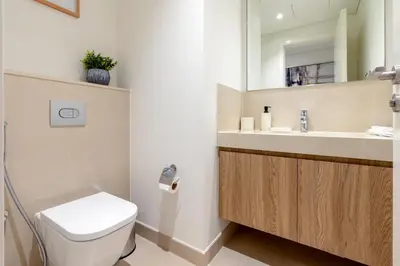 a bathroom with a toilet and a sink at 3 Bedrooms Apartment in Downtown Views - Dubai Burj Khalifa View in Dubai